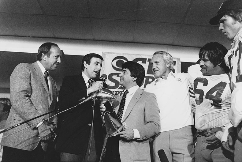 Head Coach Bill Walsh, 49ers owner Eddie DeBartolo (center), LB Dan Bunz (far right) and LB Jack Reynolds #64 after winning Super Bowl XVI 26-21 over the Cincinnati Bengals at the Silverdome in Pontiac, Michigan, 1/24/82. Photo by Michael Zagaris.