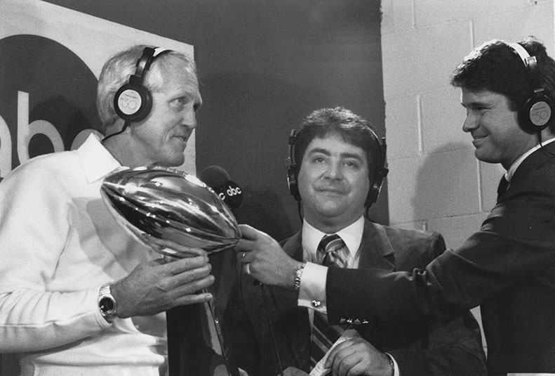 Head Coach Bill Walsh and 49ers owner Eddie DeBartolo (center) after winning Super Bowl XIX 38-16 over the Miami Dolphins at Stanford Stadium, 1/20/85. Photo by Dennis Desprois.